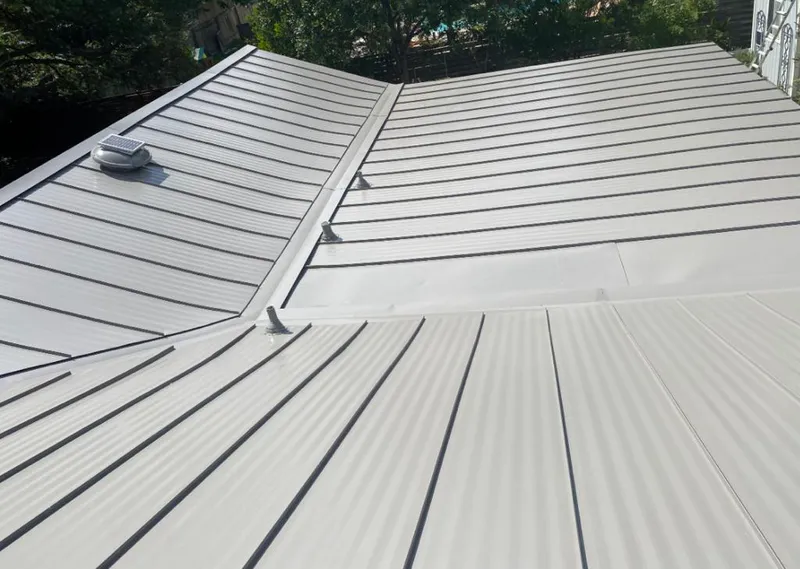Solar attic fan installed on a metal roof for Roof Ventilation in Avon